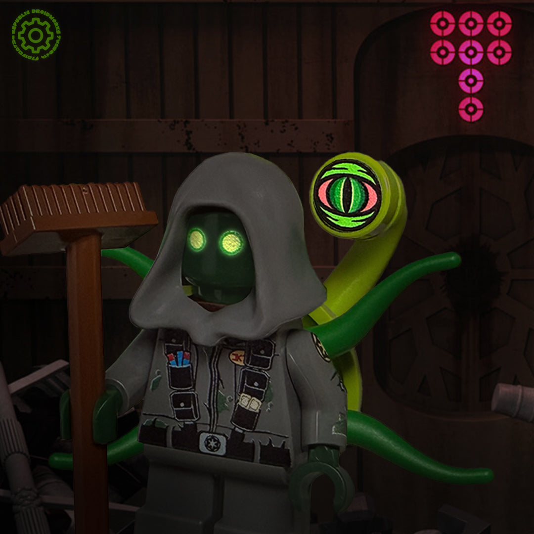Toy figure with glowing green eyes and tentacles in a dark setting. IG artwork.