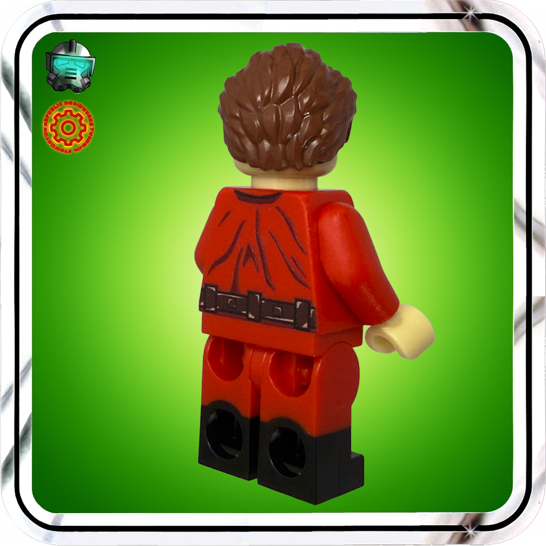 LEGO figure with red outfit and brown hair on a green background